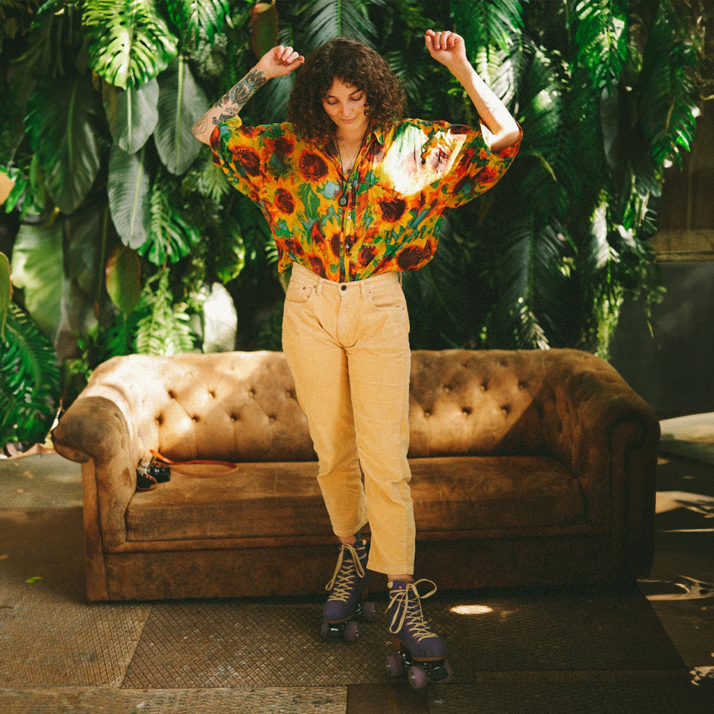 Roces-Piper-Roller-Skate-Purple-Model-Wearing-In-Front-Of-Couch